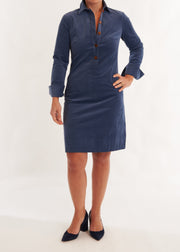 Person wearing a blue dress with a white background