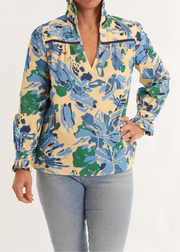 Person wearing a colorful floral jacket and light blue jeans on a white background